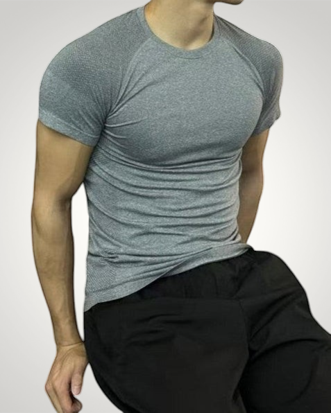 ASCEND gray seamless compression short sleeve tee on a fit model in a gym setting