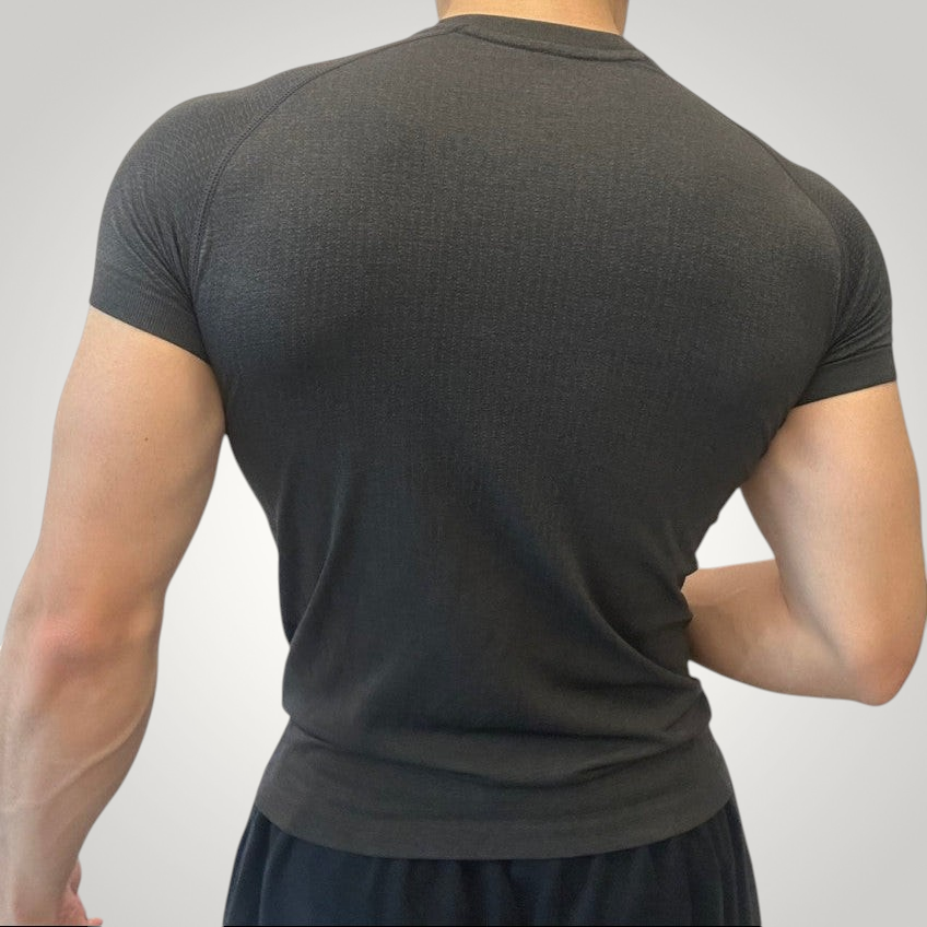 ASCEND black seamless compression t-shirt with jacquard texture worn by a muscular man, back view.