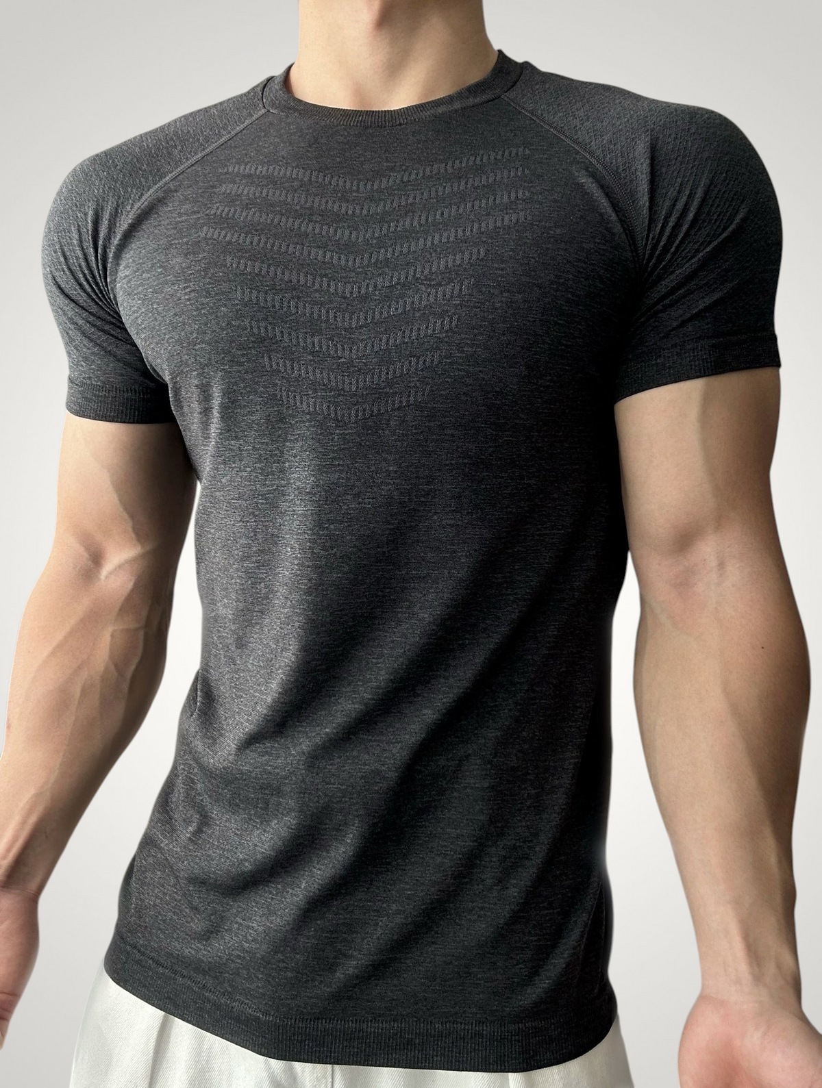 ASCEND gray seamless compression t-shirt with textured chest detailing and athletic fit on a muscular model