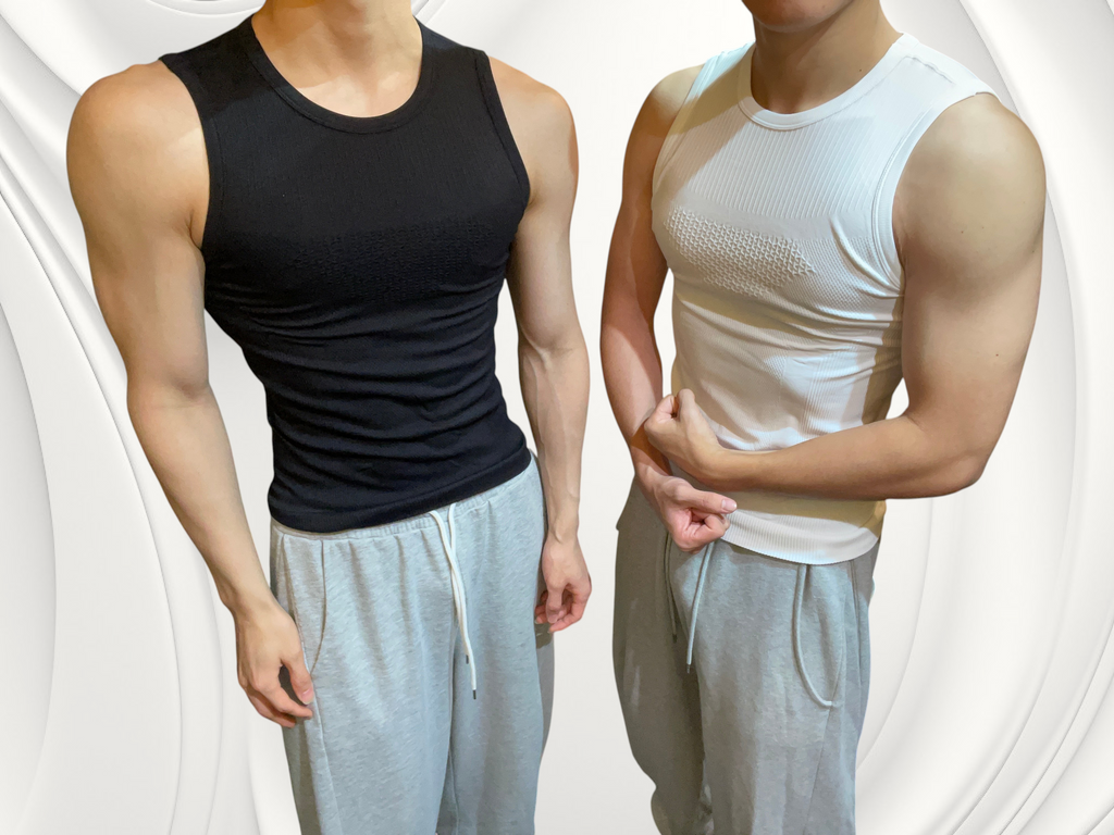 Two men wearing ASCEND textured compression tank tees in black and white with grey sweatpants in a gym setting.