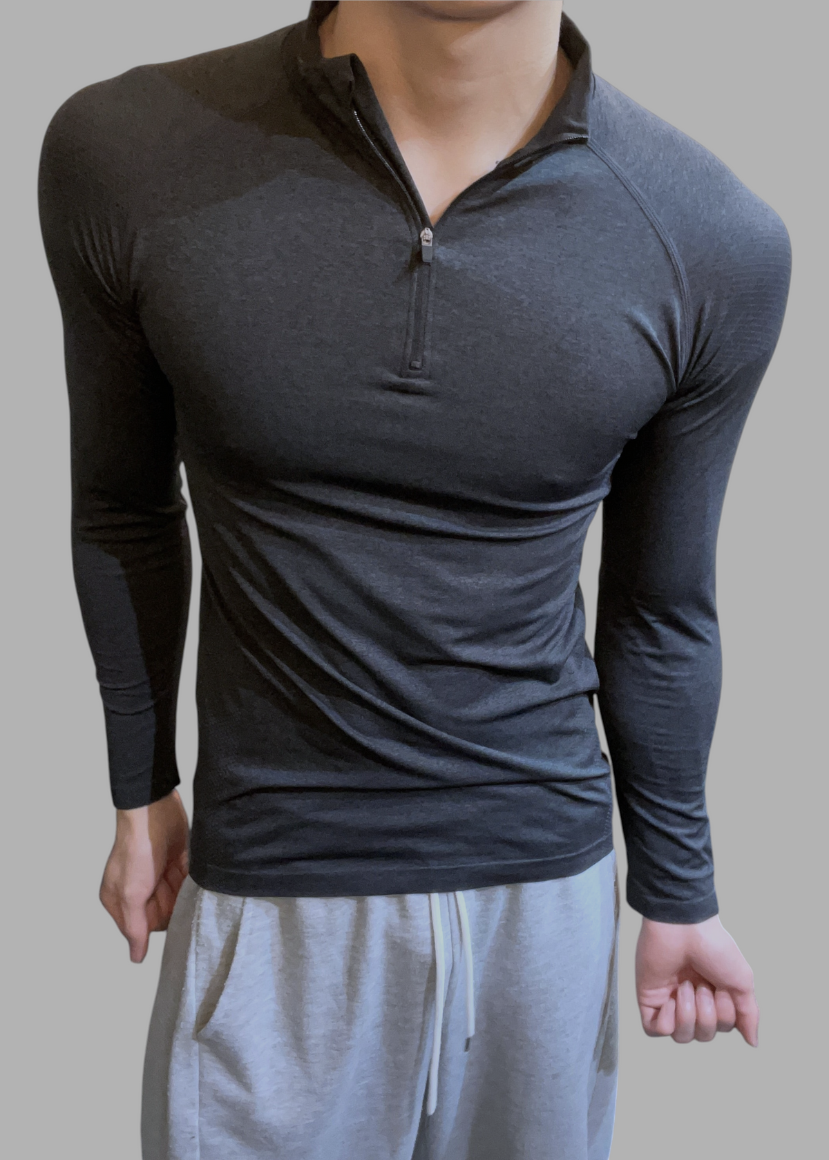ASCEND charcoal grey long sleeve zip-up tee with shoulder detailing worn by a man
