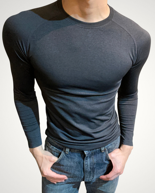 ASCEND black compression long sleeve tee with shoulder detailing worn by a model for a muscular fit.