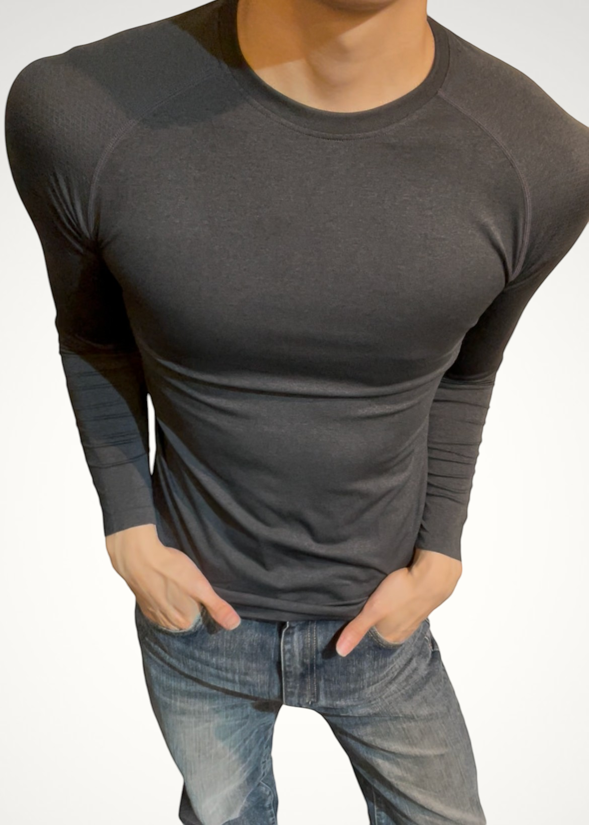 ASCEND black compression long sleeve tee with seamless shoulder detailing on a male model