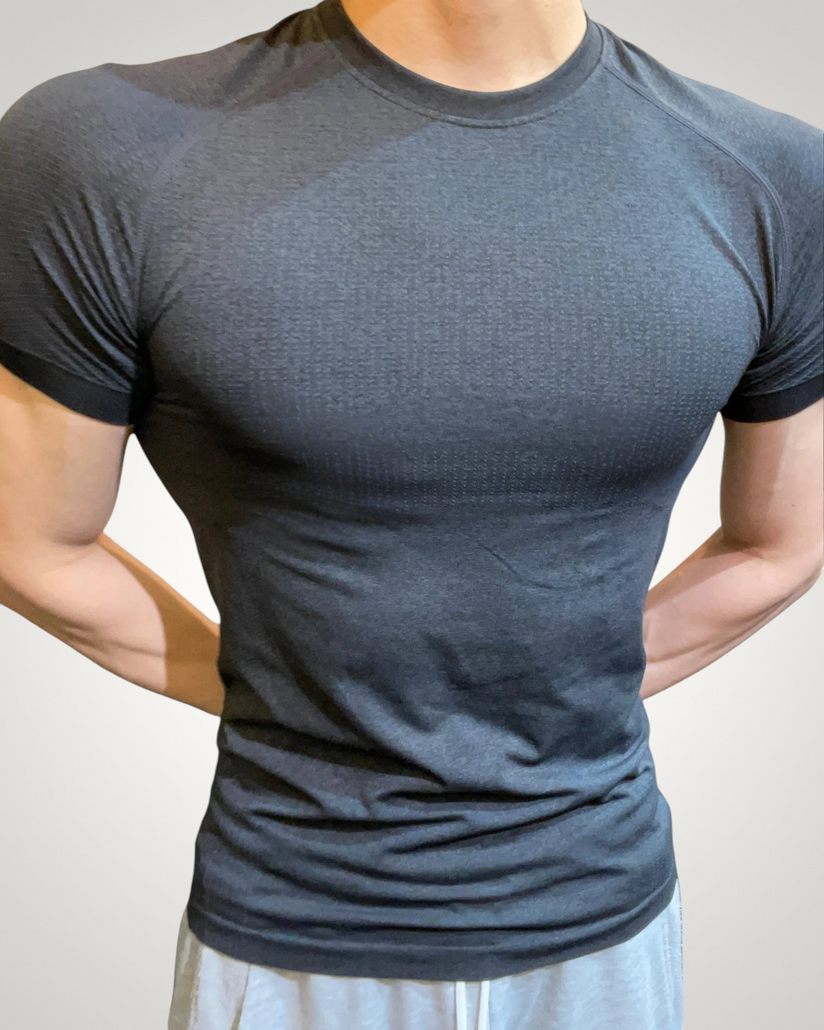 ASCEND black seamless compression tee with a tight fit, designed for athletic training and muscle definition.