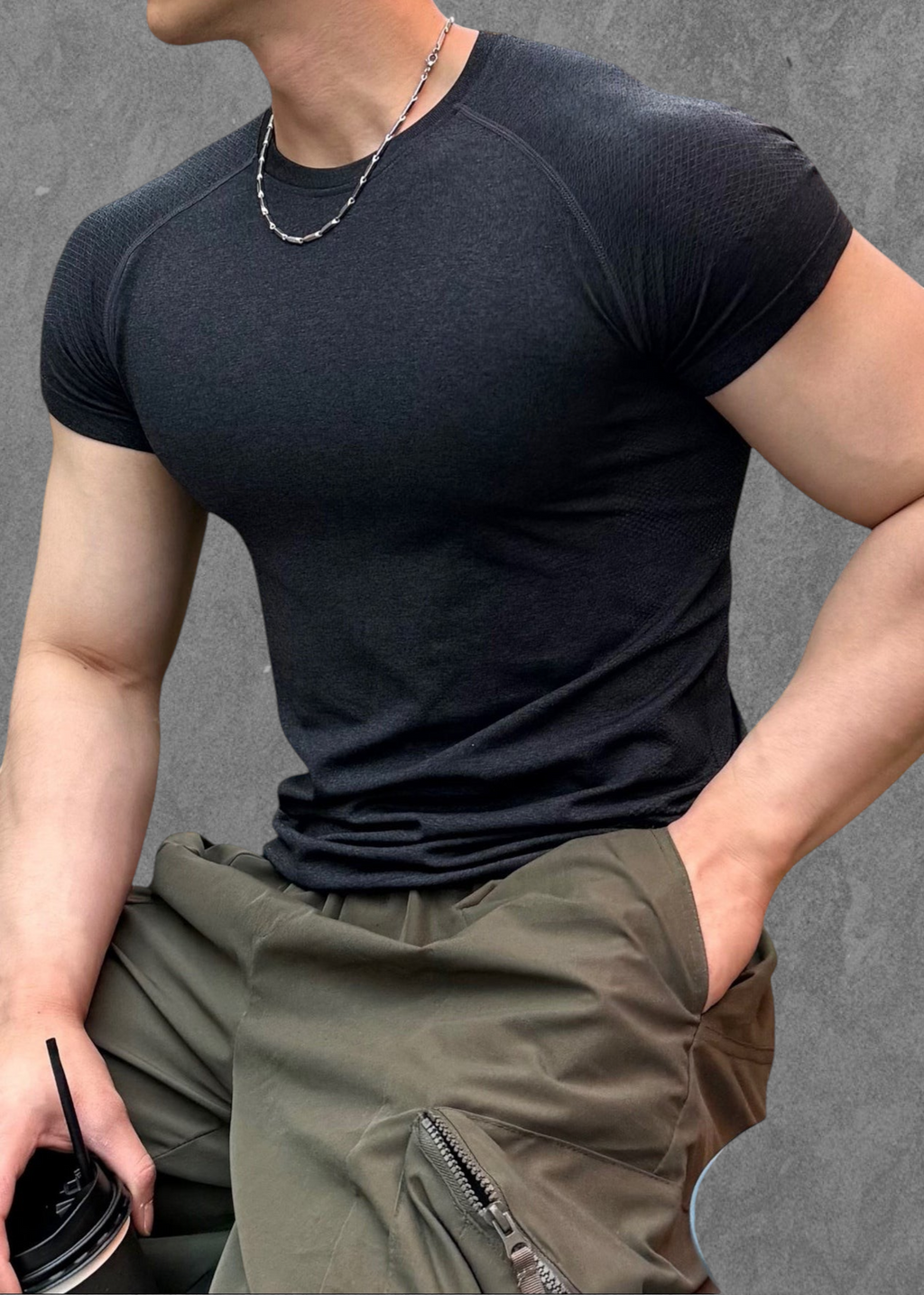 ASCEND black seamless compression short sleeve tee with athletic fit worn by a muscular model outdoors