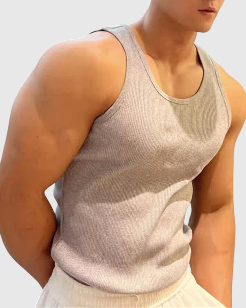 ASCEND grey ribbed compression tank top worn by a muscular man, perfect for athletic training and gym workouts.