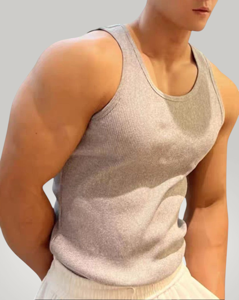 ASCEND grey ribbed compression tank top worn by a muscular man, perfect for athletic training and gym workouts.