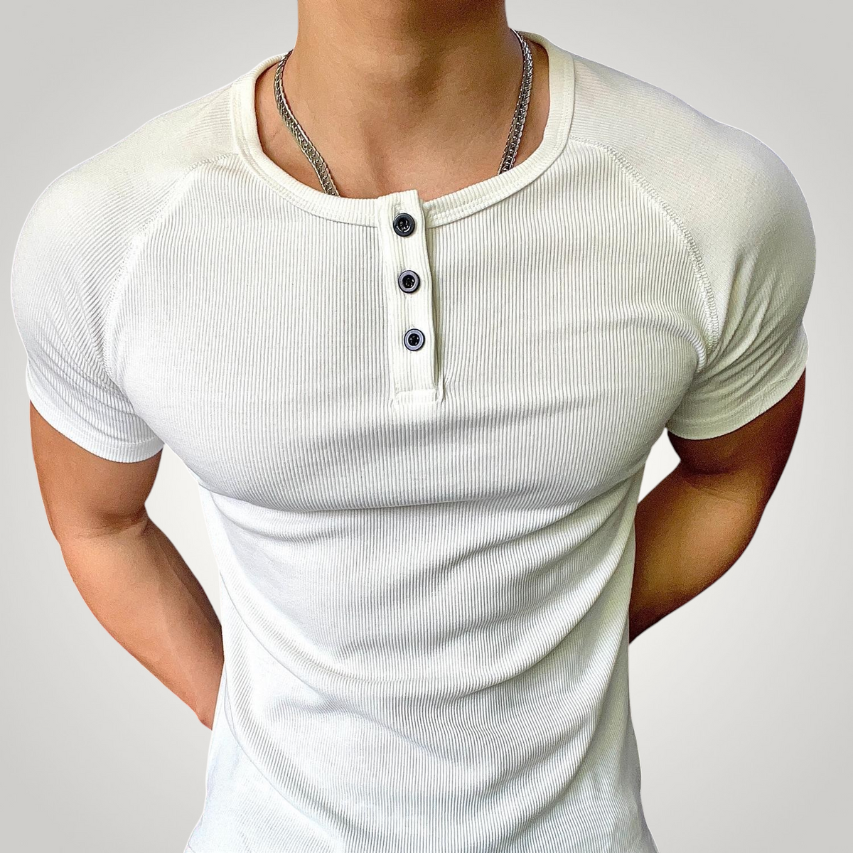 ASCEND white ribbed henley neck compression t-shirt worn by a muscular man in a gym setting