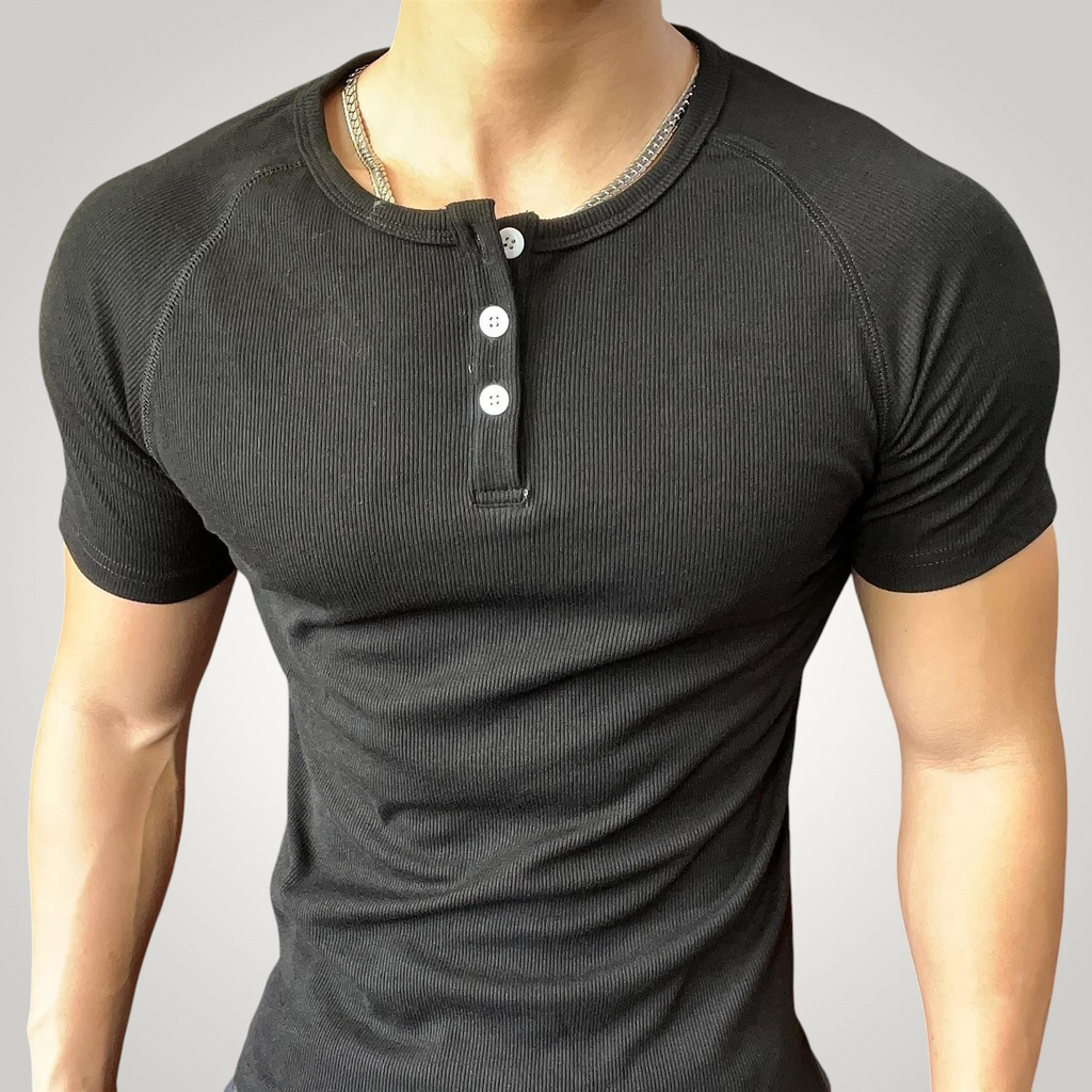 ASCEND black ribbed henley neck compression t-shirt with short sleeves worn by a muscular man in a gym setting