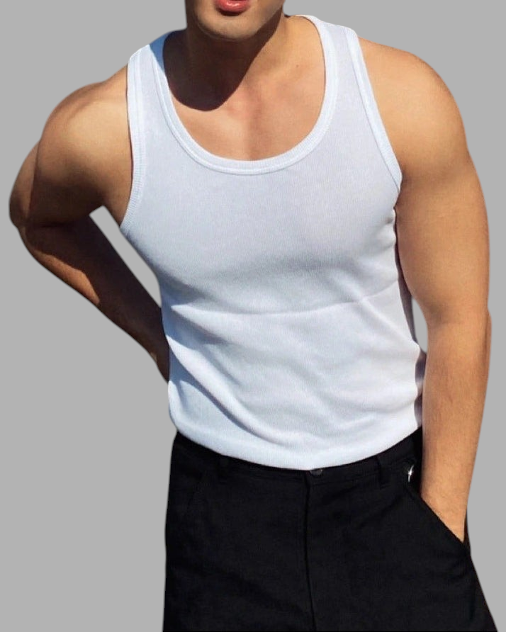 ASCEND white ribbed compression tank top worn by a muscular man with black trousers