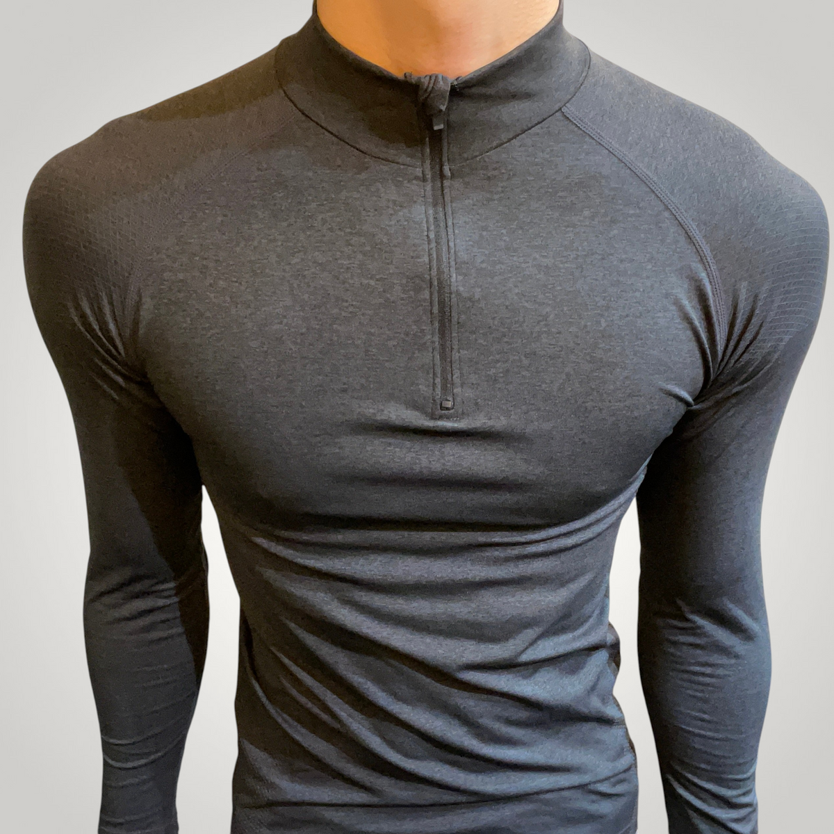 ASCEND black seamless compression long sleeve zip-up tee with athletic fit on a male model