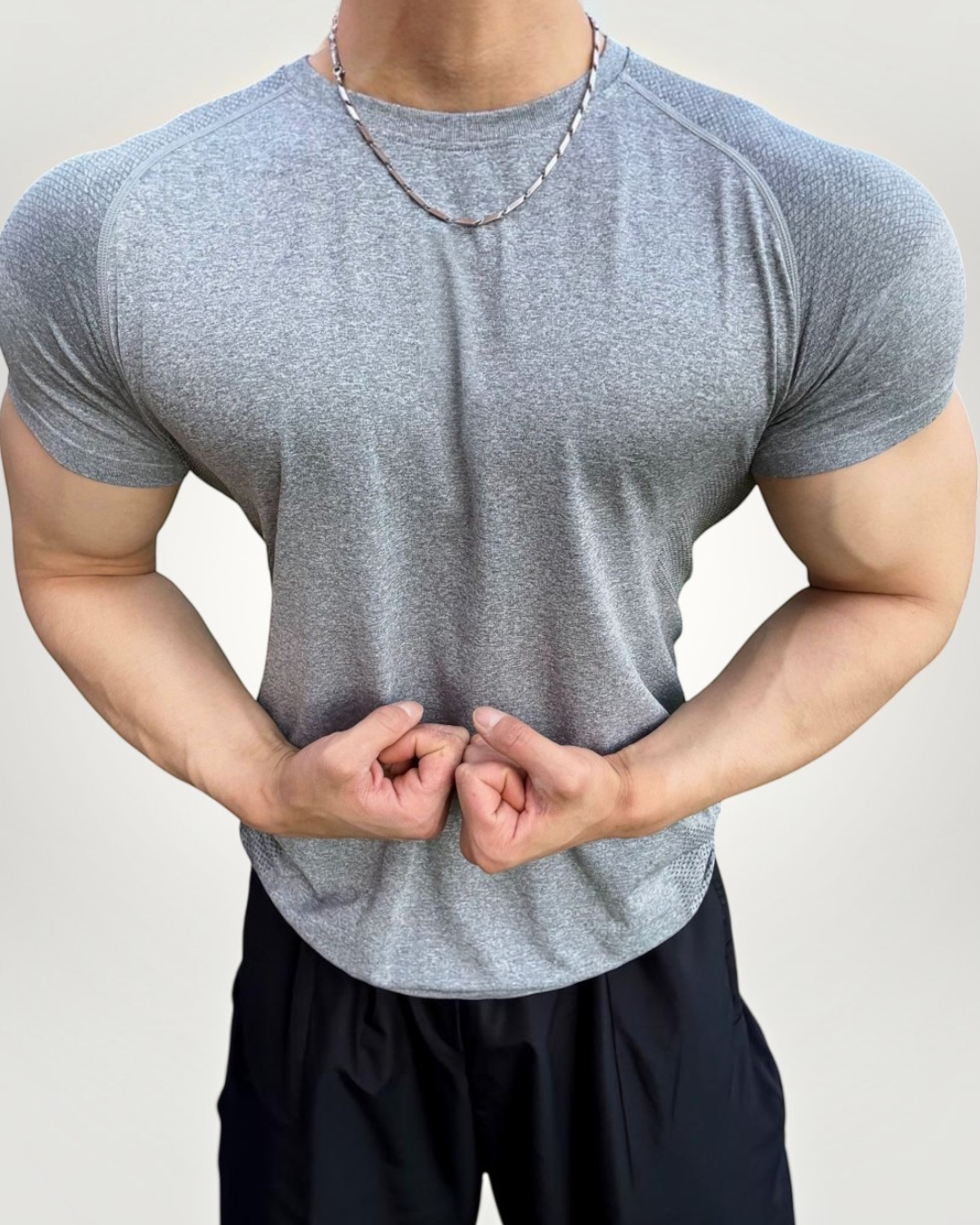 ASCEND gray seamless compression short sleeve tee with athletic fit on a muscular model outdoors