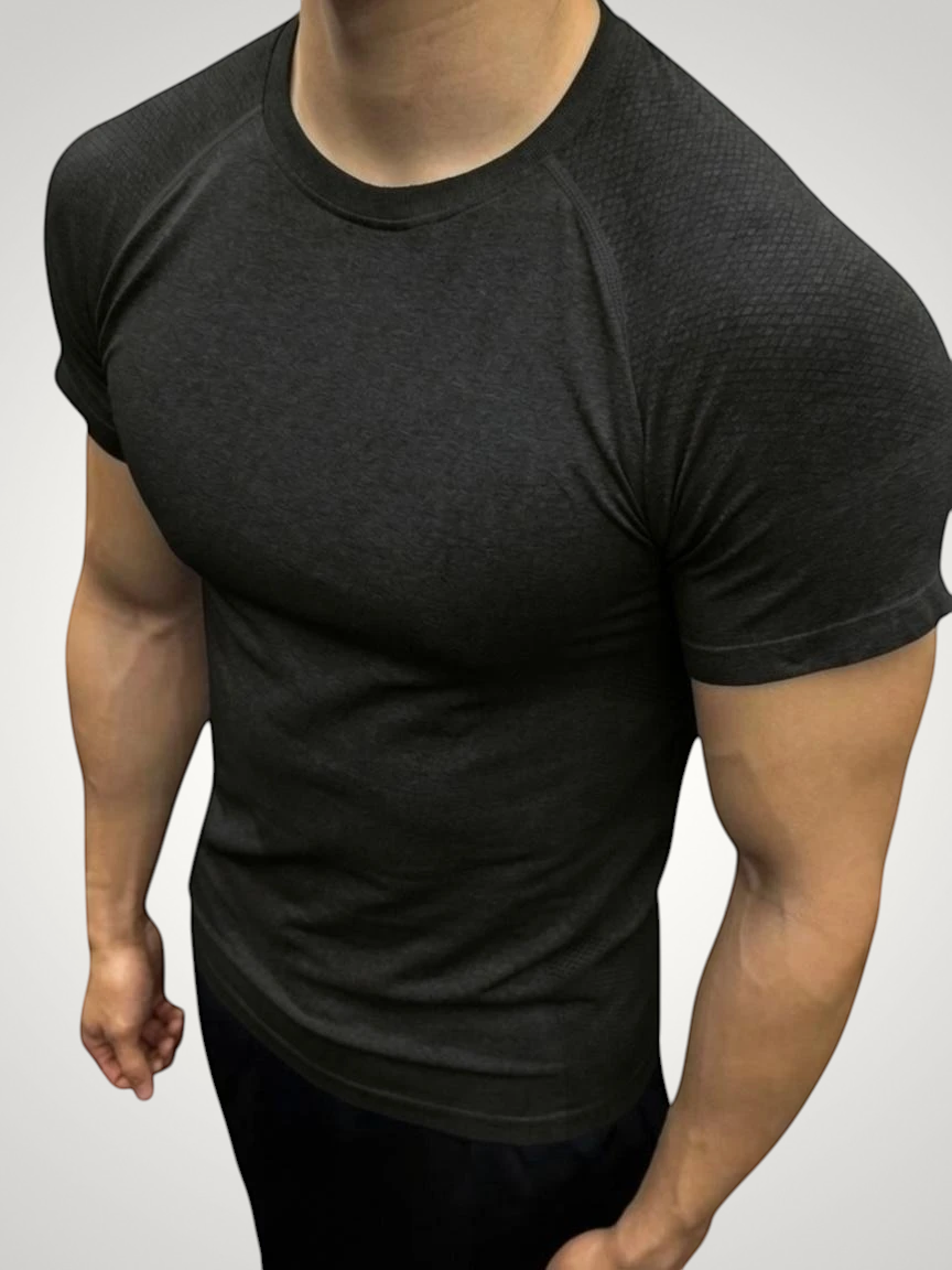 ASCEND gray seamless compression short sleeve tee with textured shoulder detailing on a muscular model