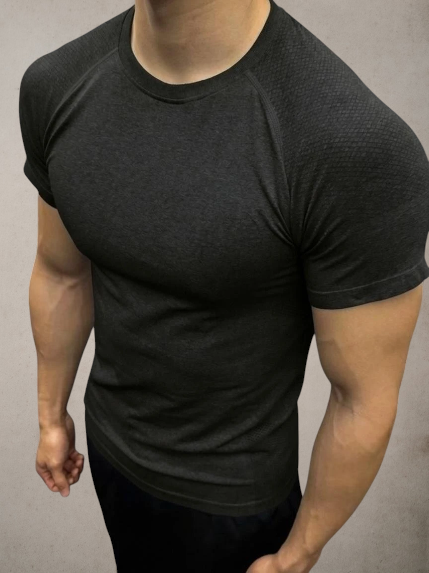 ASCEND gray seamless compression short sleeve tee with textured shoulder detailing on a muscular model