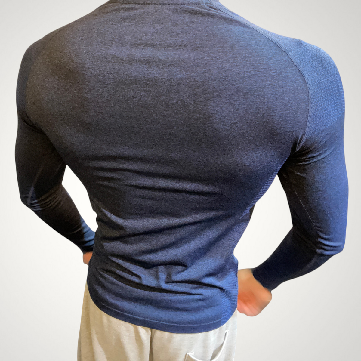 ASCEND navy blue compression long sleeve tee with shoulder detailing worn by a male model from the back view